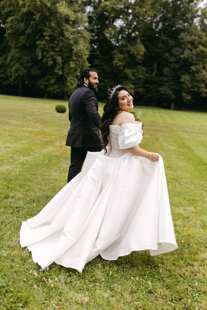 Chateau wedding couple posing in the garden